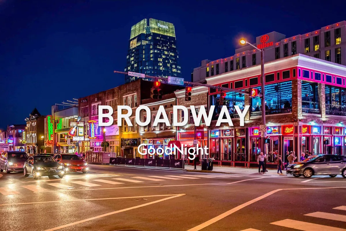 A lively nighttime city scene featuring neon signs, busy streets filled with people, and high-rise buildings. The energetic atmosphere captures the essence of Nashville's downtown nightlife, with crowds moving between dining, live music, and entertainment venues.